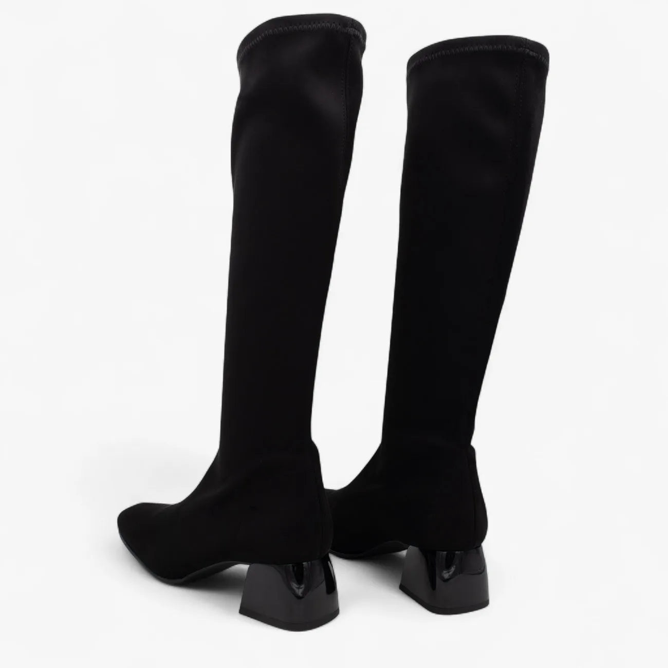 Black knee-high boots on a white background