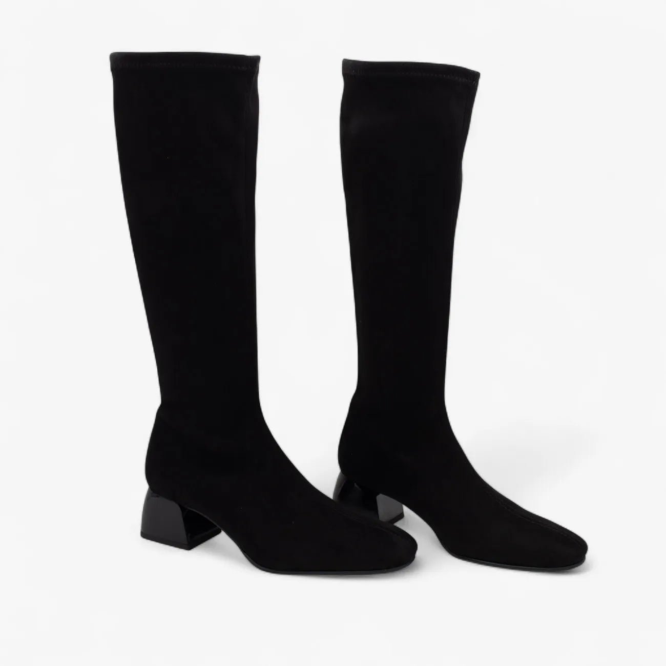 Pair of black knee-high boots on a white background