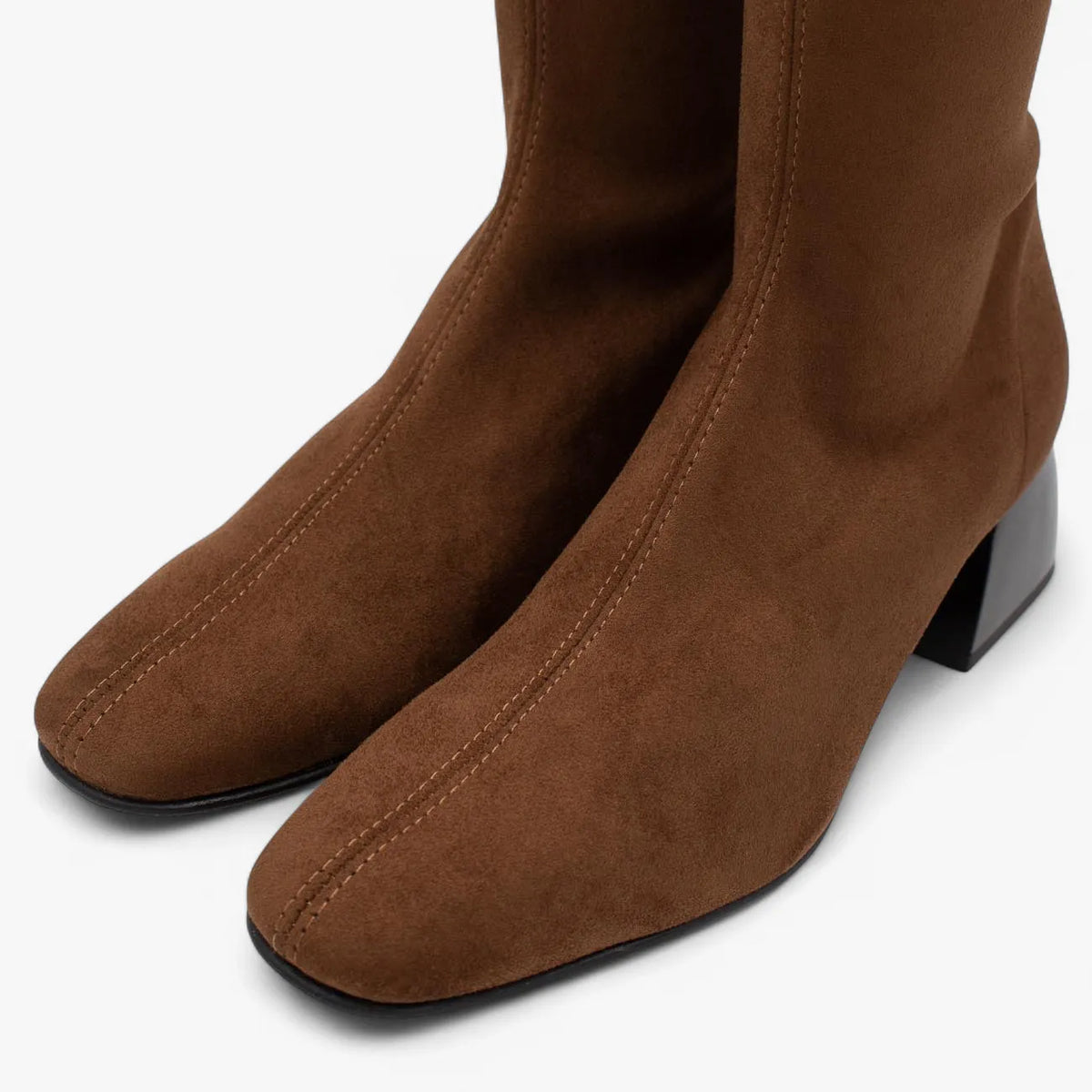 Brown suede knee-high boots on a white background