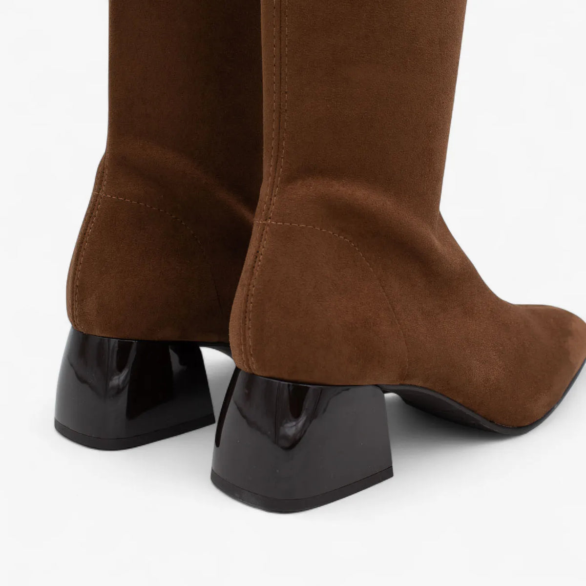 Brown knee-high boots with black block heels on a white background