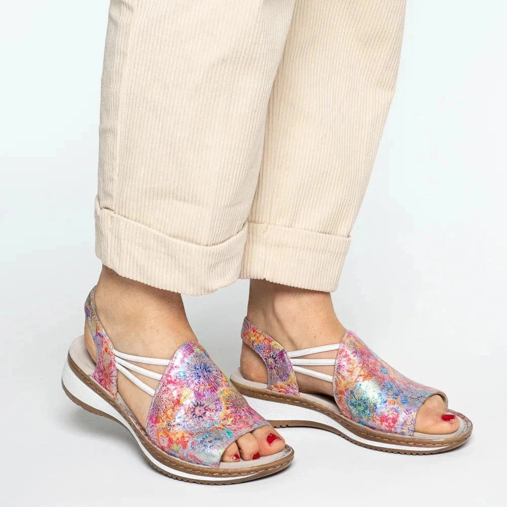 Colorful sandals worn with beige pants on a white background