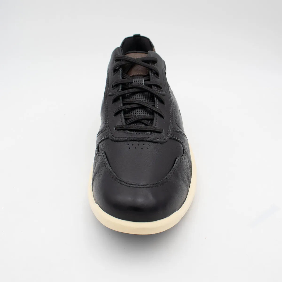 Black sneaker with a white sole on a light grey background