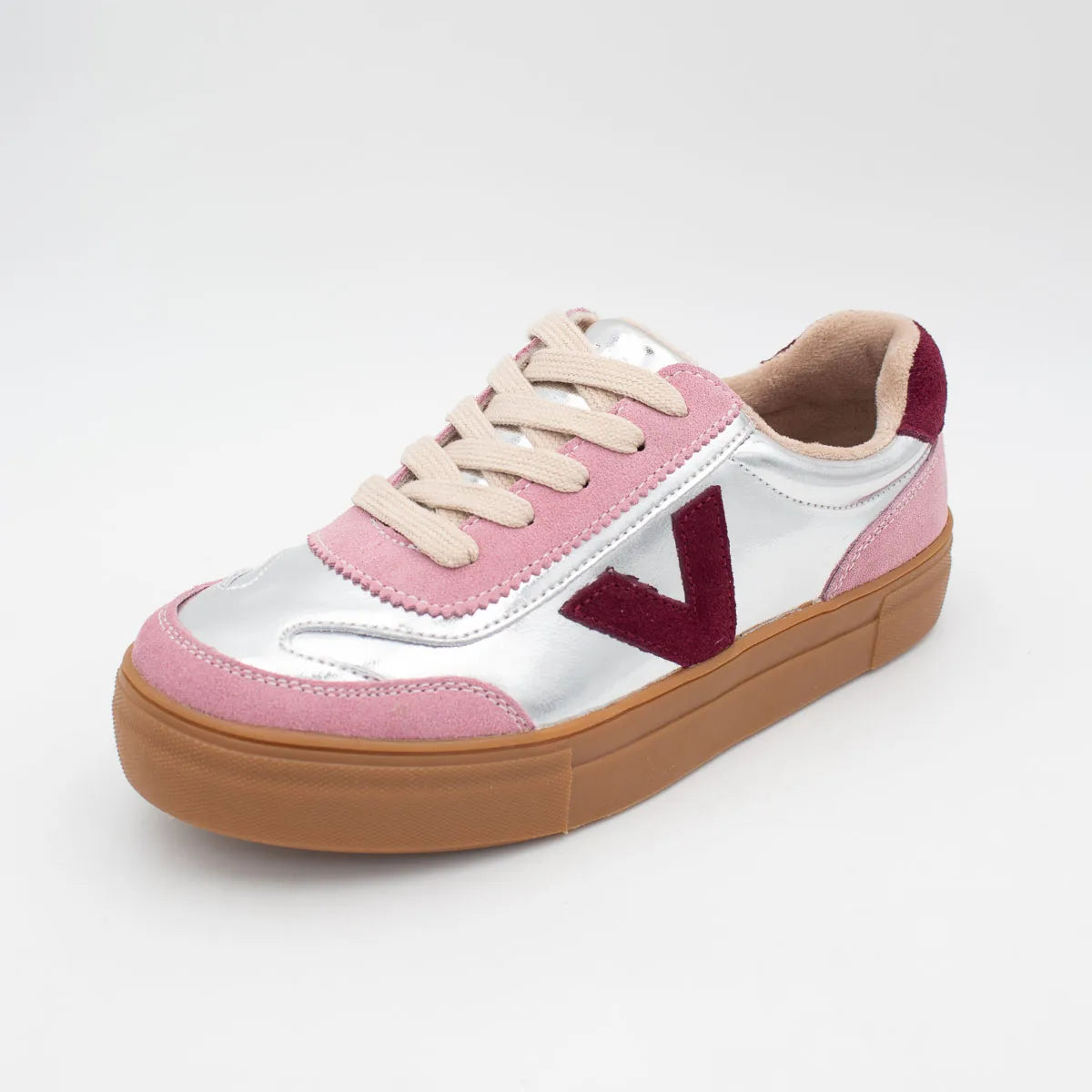Pink and white sneaker with brown sole on a white background