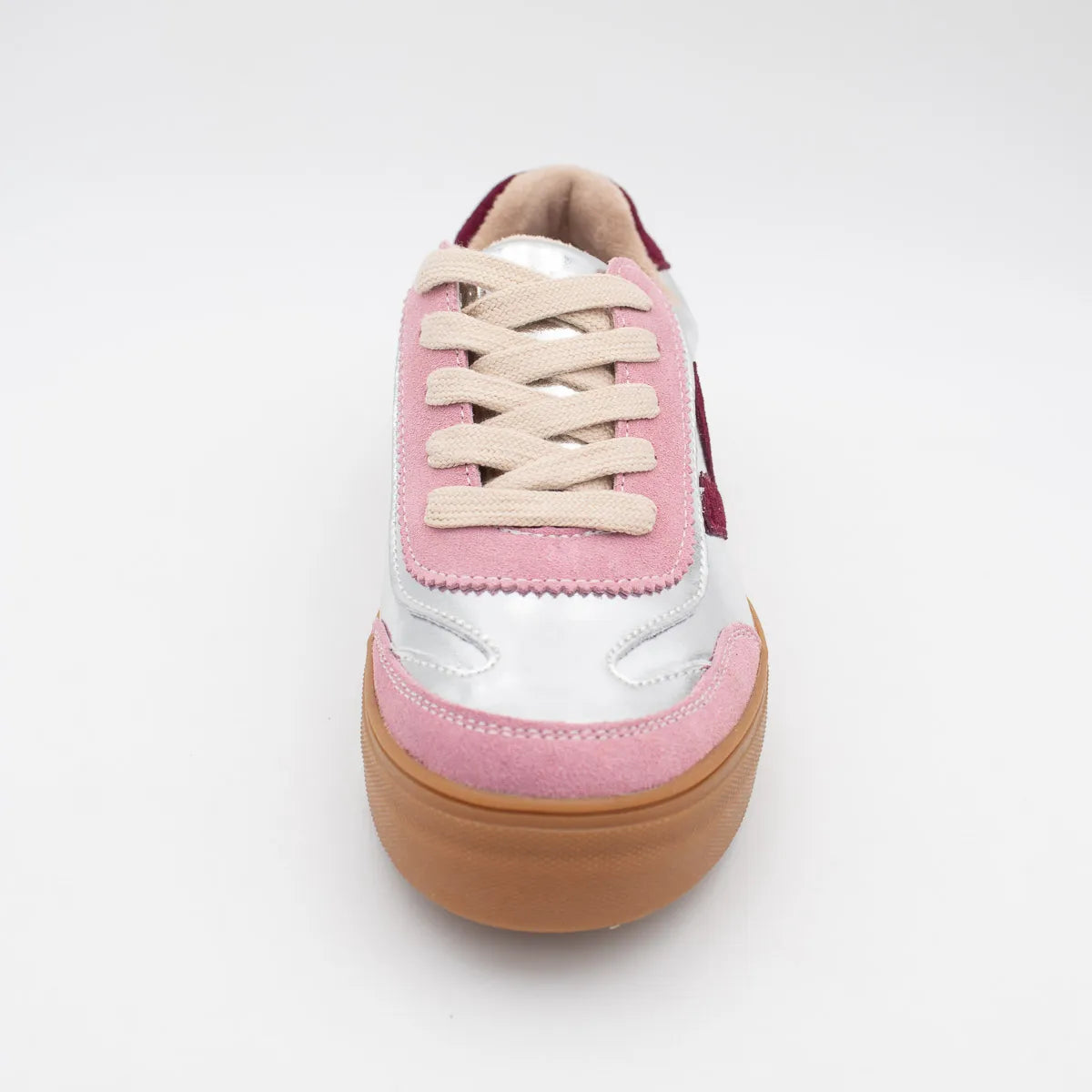 Pink and white sneaker with a brown sole on a white background