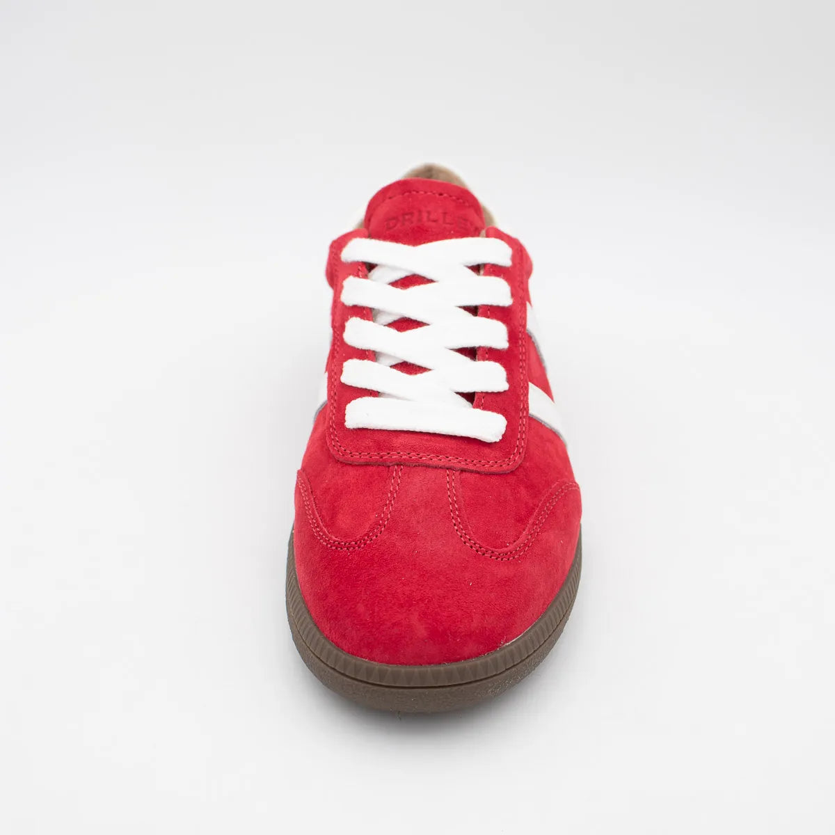 Red sneaker with white laces on a light gray background