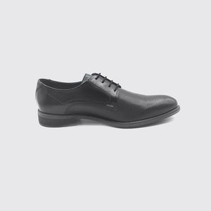 Side view of the shoe, showing the block heel and pin hole design.