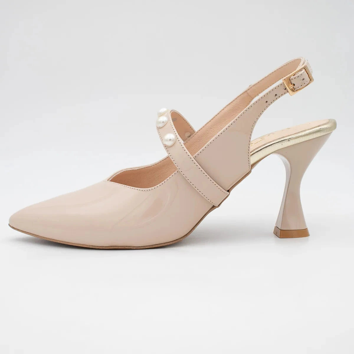Beige high-heeled shoe with a strap and pearl detail on a light gray background