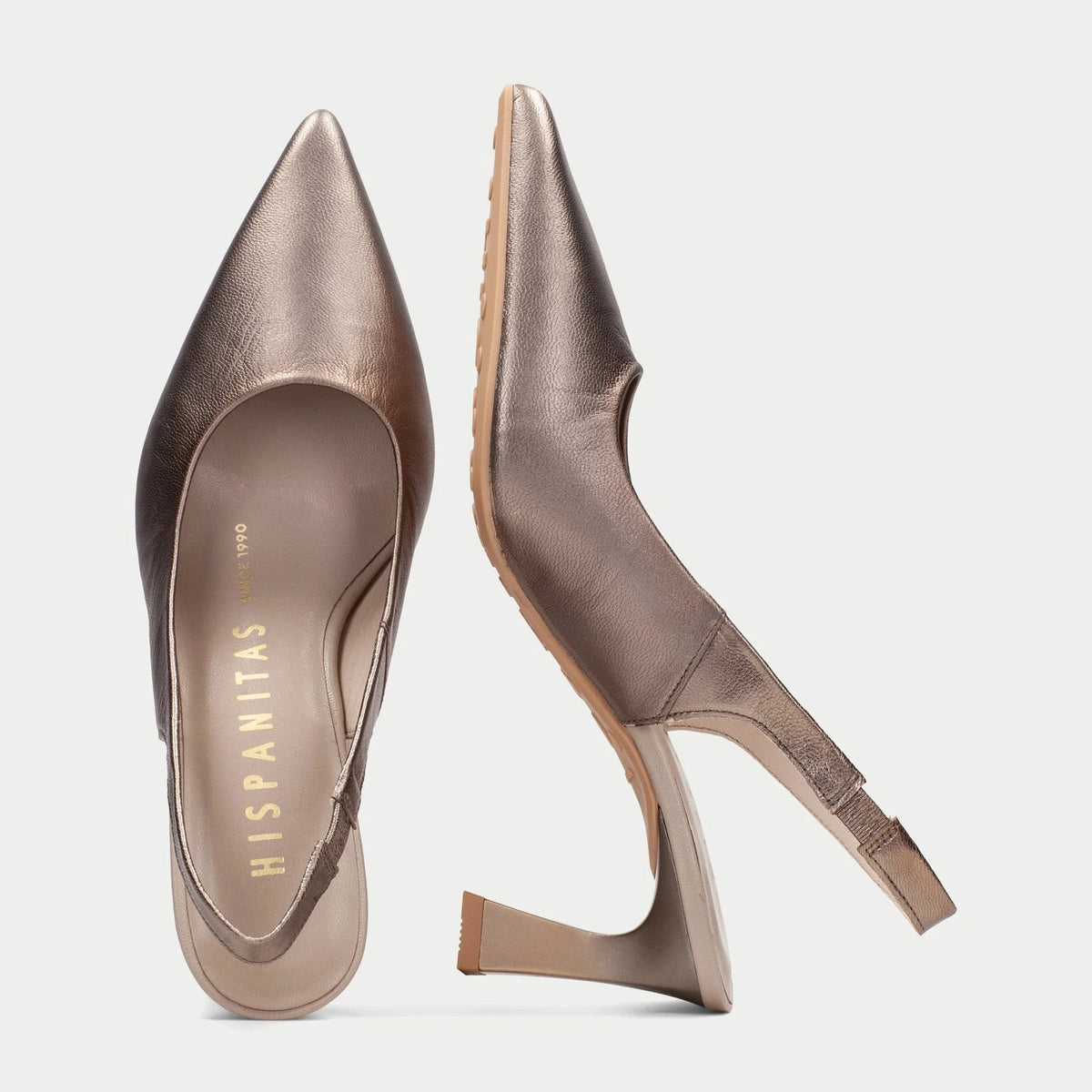 Pair of metallic high-heeled shoes on a light gray background