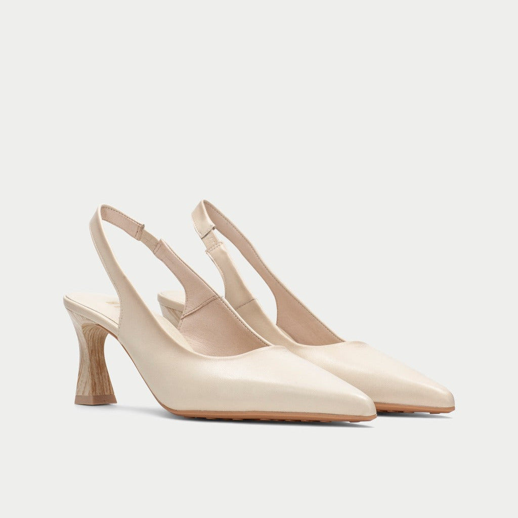 Pair of beige slingback heels on a light gray background