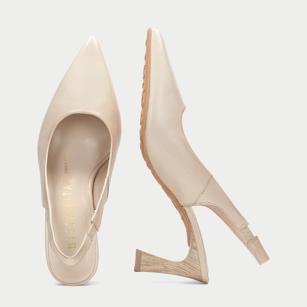 Pair of beige high-heeled shoes on a light gray background