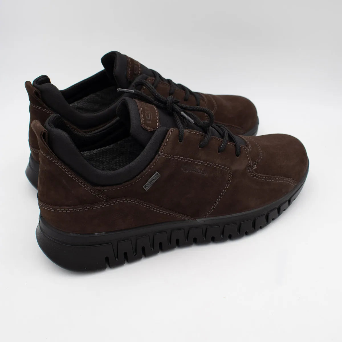 Pair of brown suede shoes with black soles on a white background