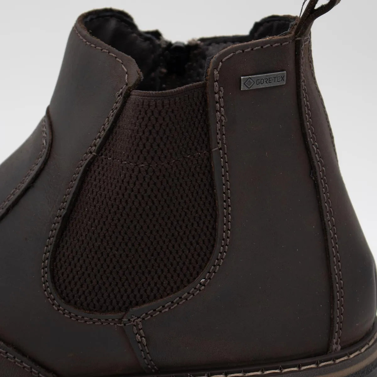Brown leather boot with mesh panel on a white background