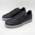Black sneakers with a zipper on a white background