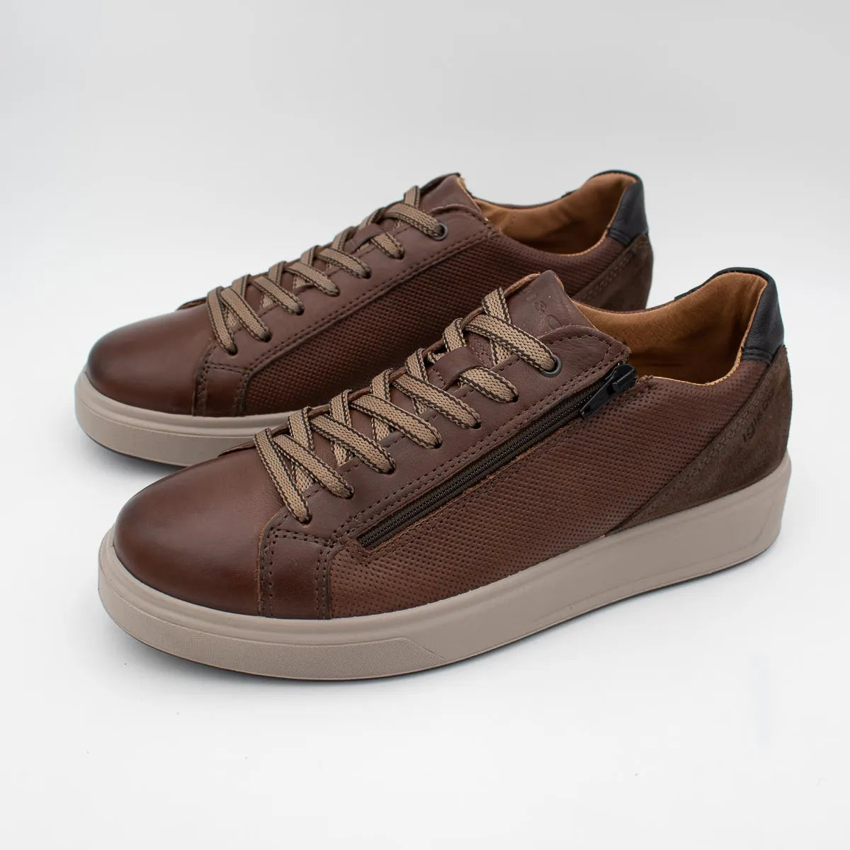 Pair of brown sneakers with beige laces on a white background