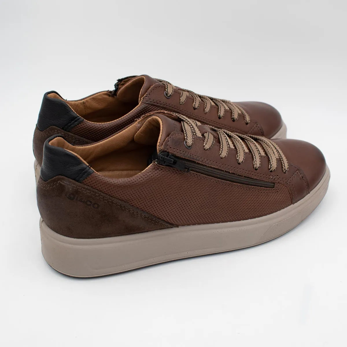 Brown sneakers with a visible brand logo on a white background