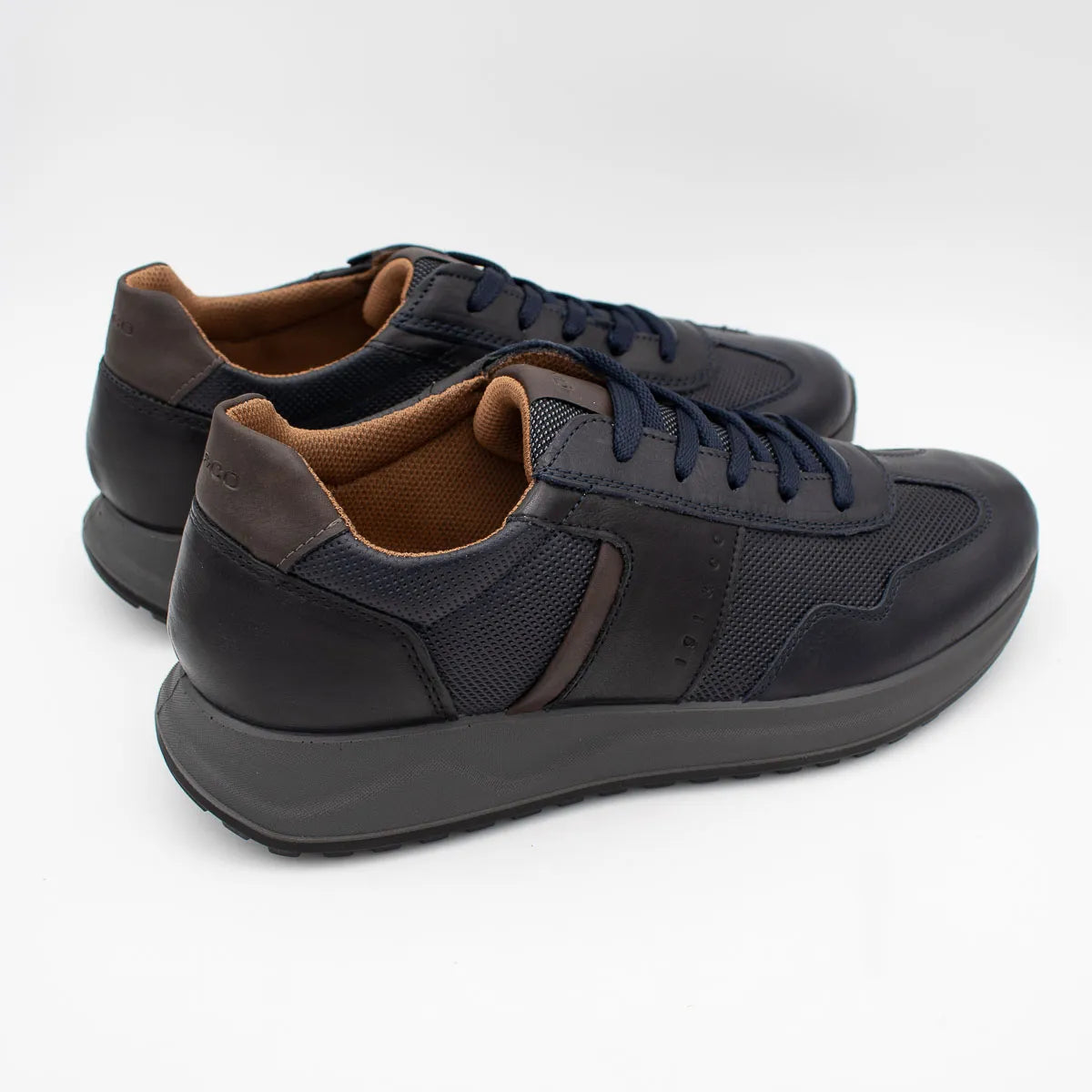 Pair of black sneakers with brown accents on a white background