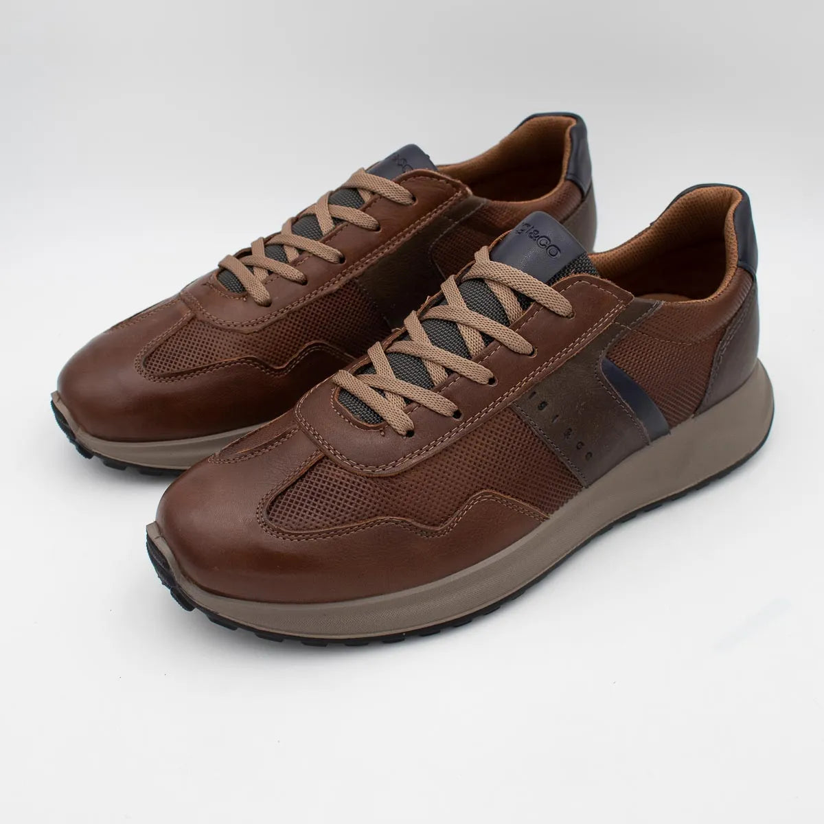 Pair of brown leather sneakers on a white background