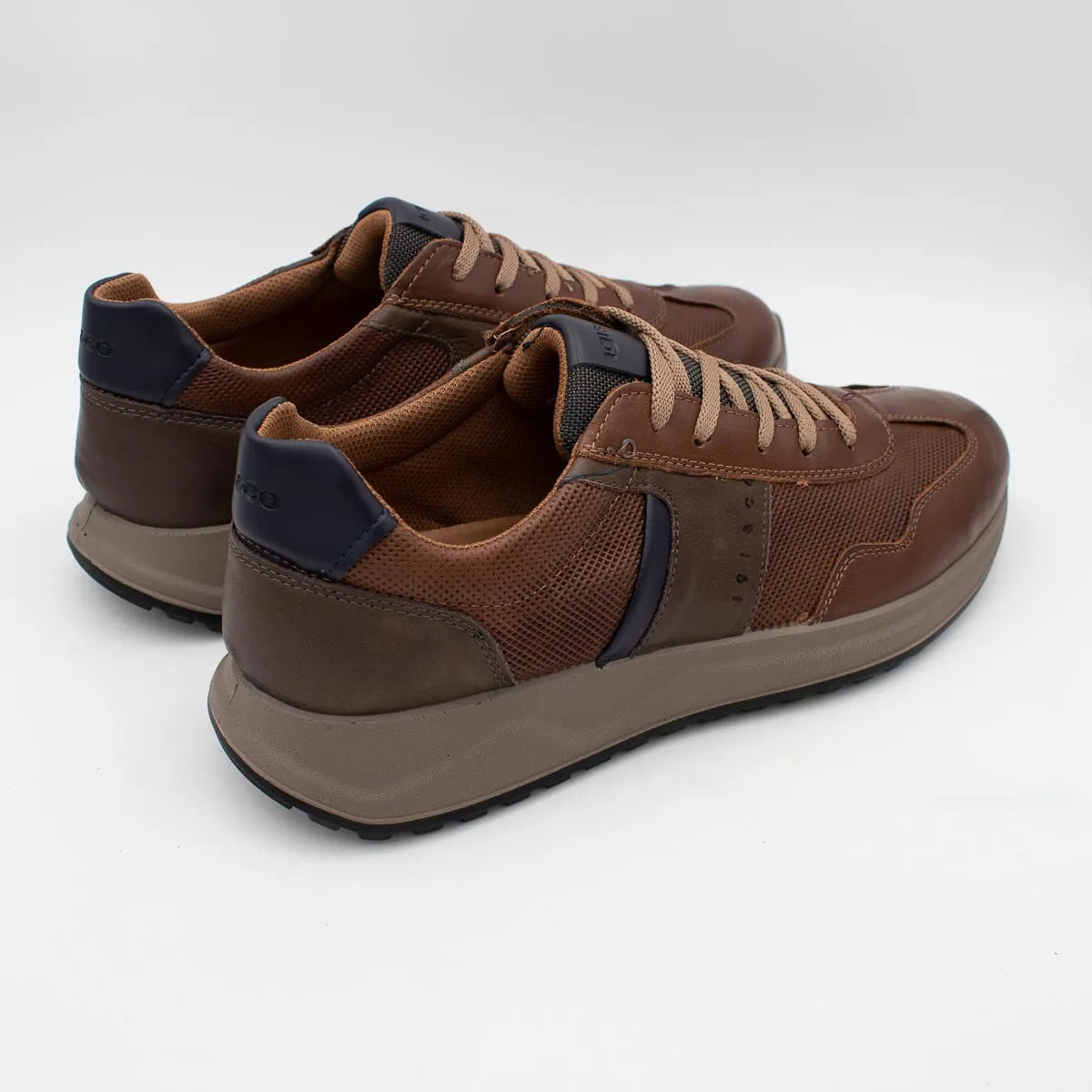 Pair of brown and navy sneakers on a white background