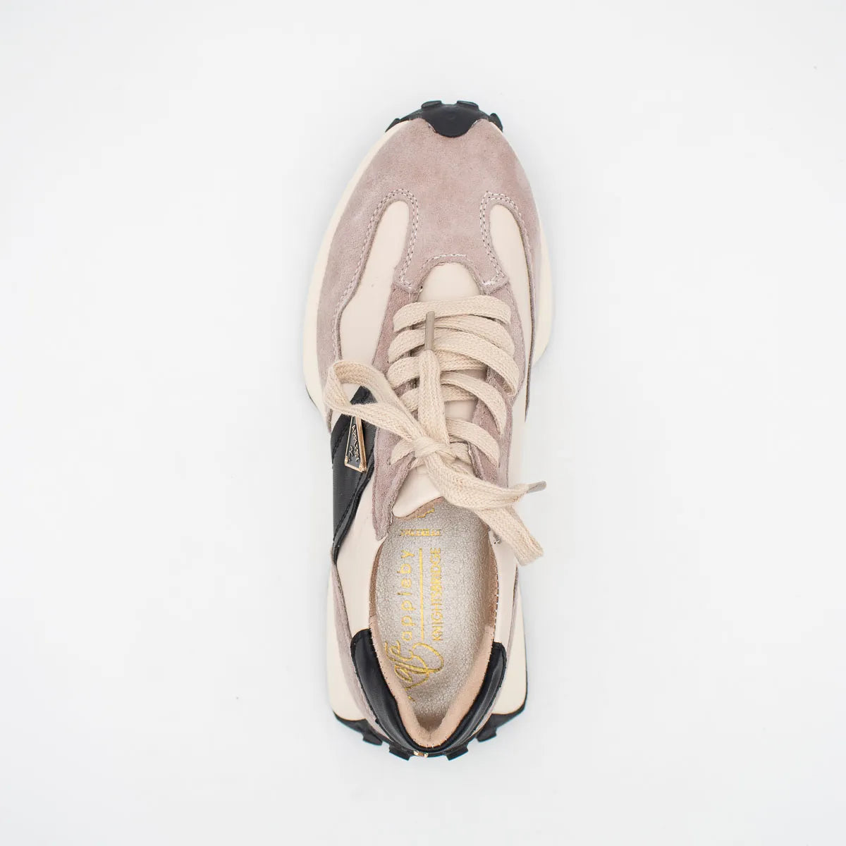 Sneaker with beige and black design on a white background