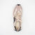 Sneaker with beige and black design on a white background