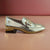     Front view of Zanni & Co Cream Square Toe Loafer with gold chain link.