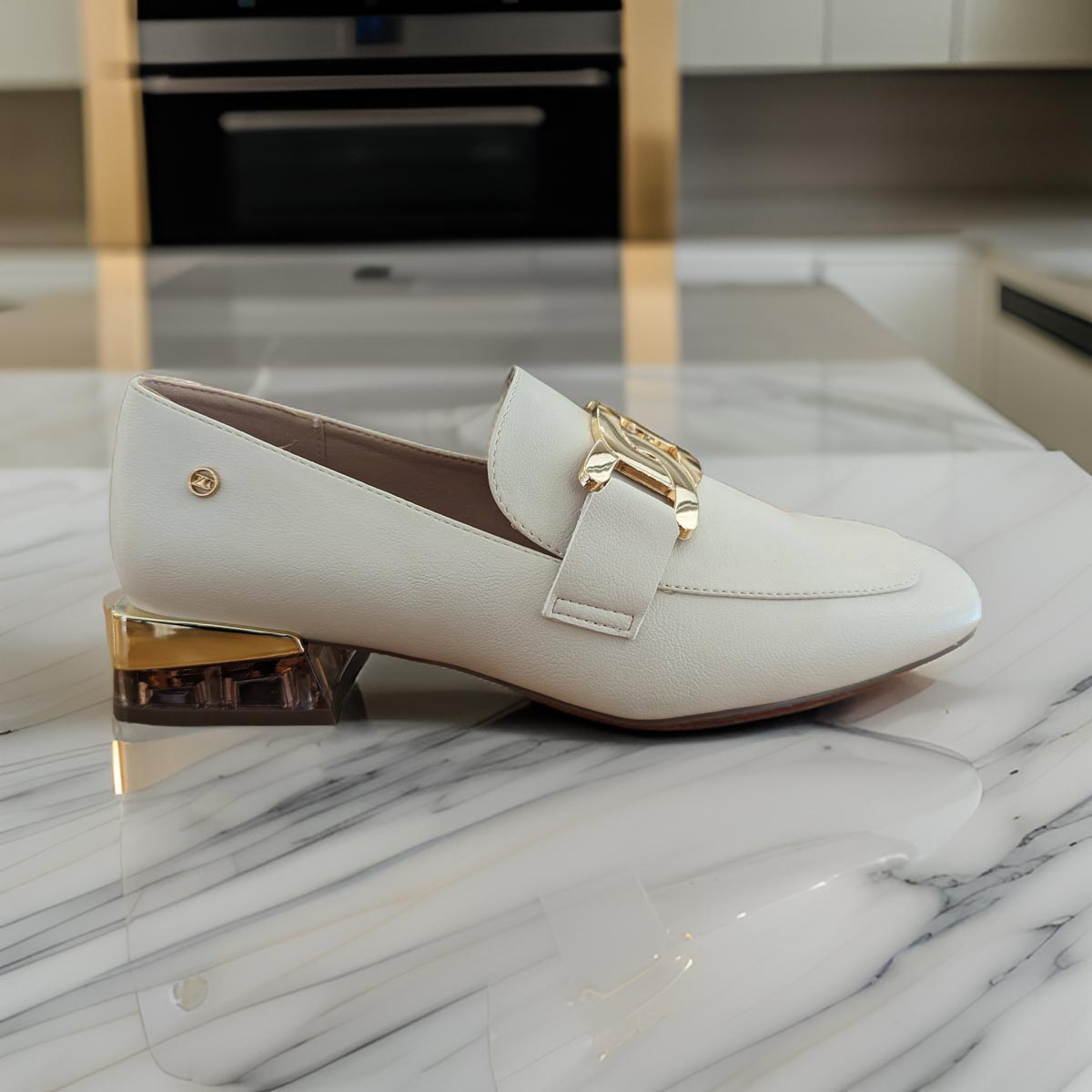     Front view of Zanni & Co Cream Square Toe Loafer showcasing the gold chain link.