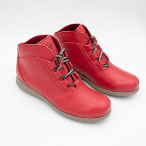 Diagonal perspective of red ankle boots pair.