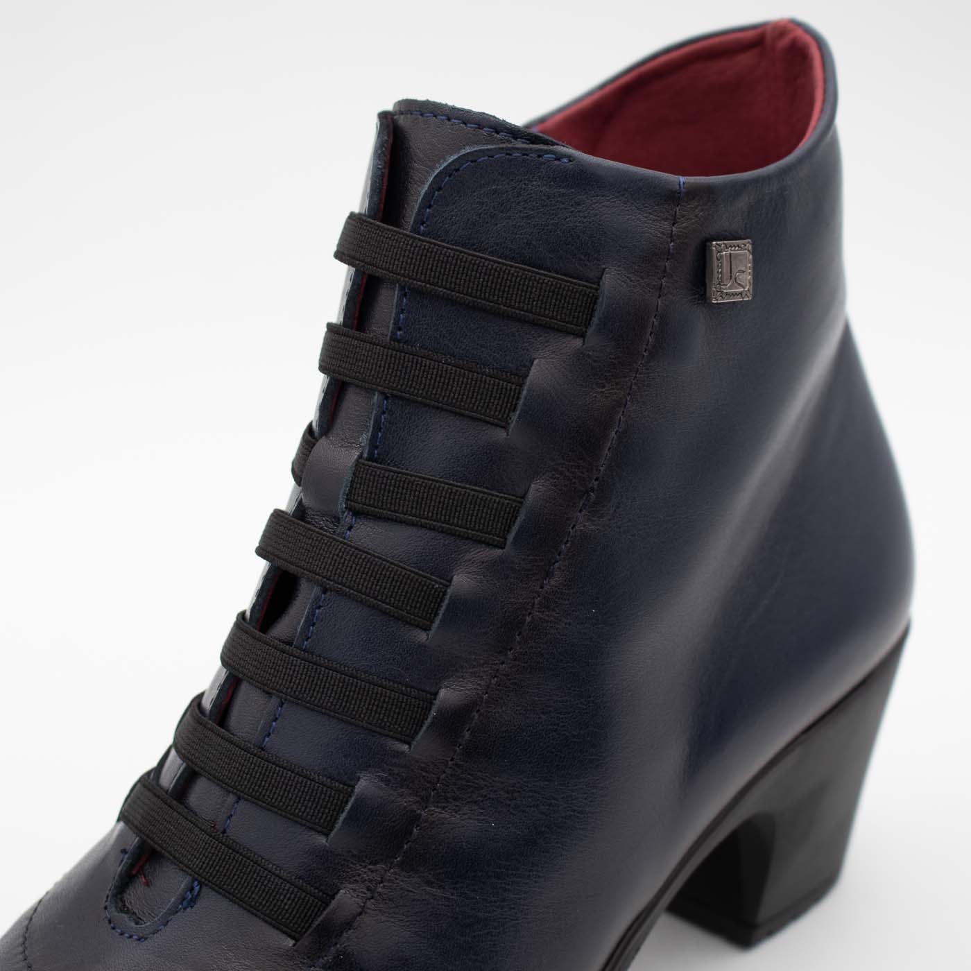 Side profile of Jose Saenz navy smooth leather ankle boot.