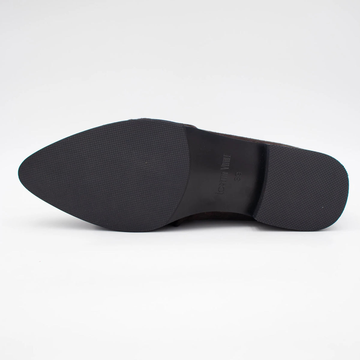 The black rubber outsole of a pointed-toe dress shoe, showing the brand name 'Loretta Vitale' embossed on the heel, photographed against a seamless white background.