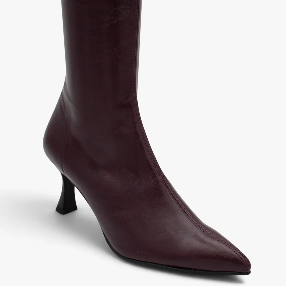 Close-up of the pointed toe, smooth burgundy upper and flared heel on the Miss Elastic Zeta boot.