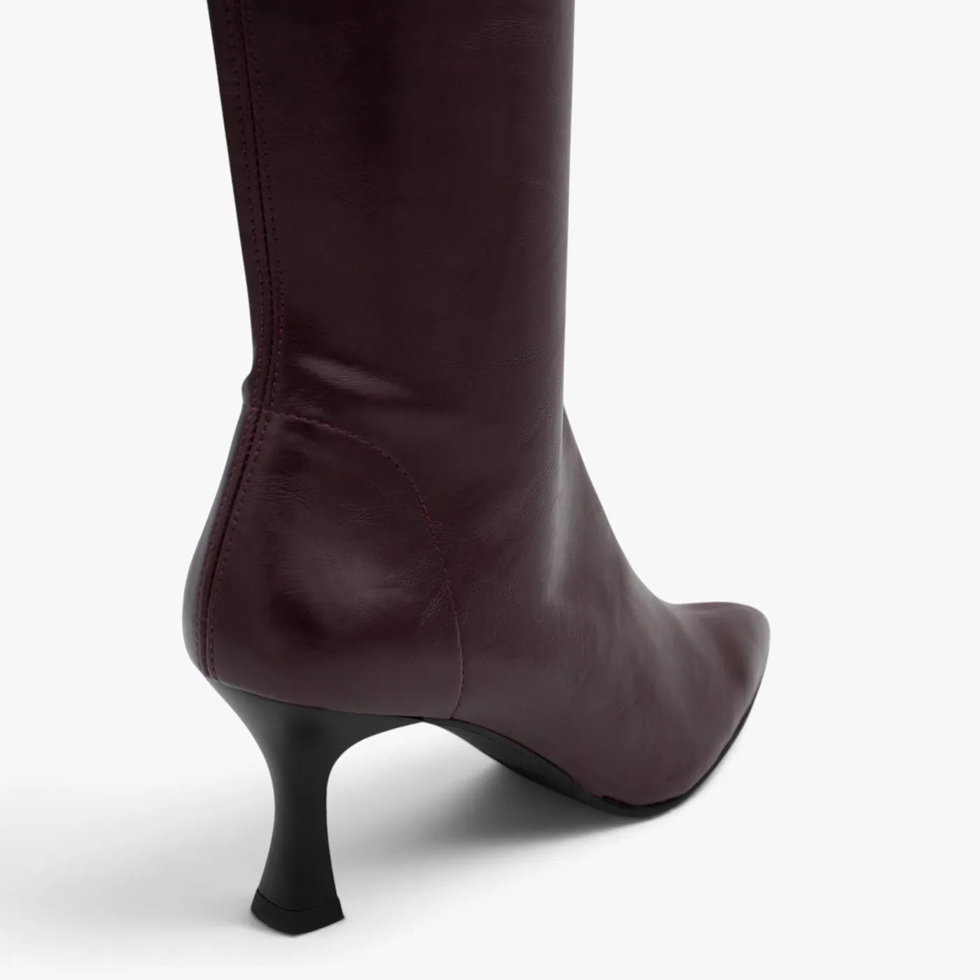 Close-up of the burgundy stretch upper and black flared heel on the Miss Elastic Zeta boot.