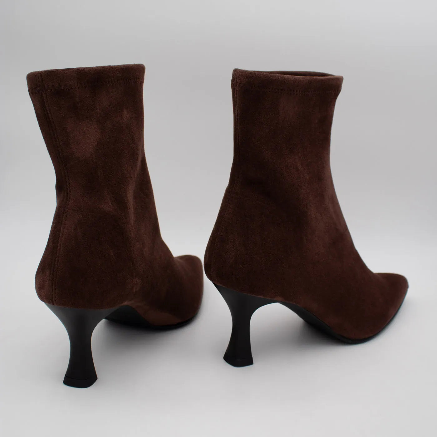 Rear view of a pair of Miss Elastic Zeta brown ankle boots, showing the heel seams and flared heels.