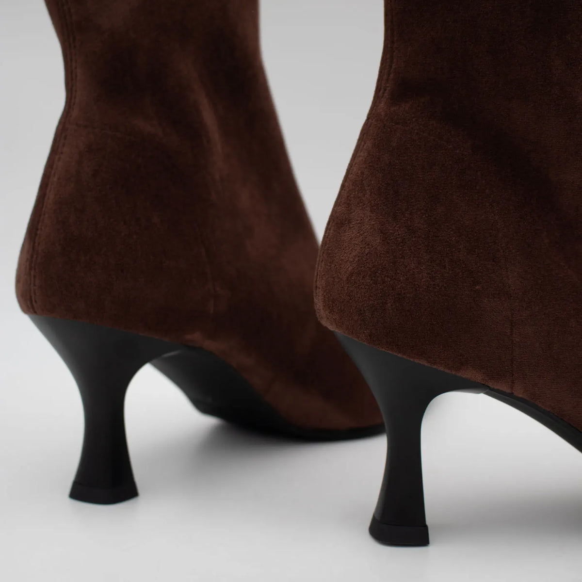 Close-up of the black flared heels and brown suede-effect uppers on the Miss Elastic Zeta ankle boots.