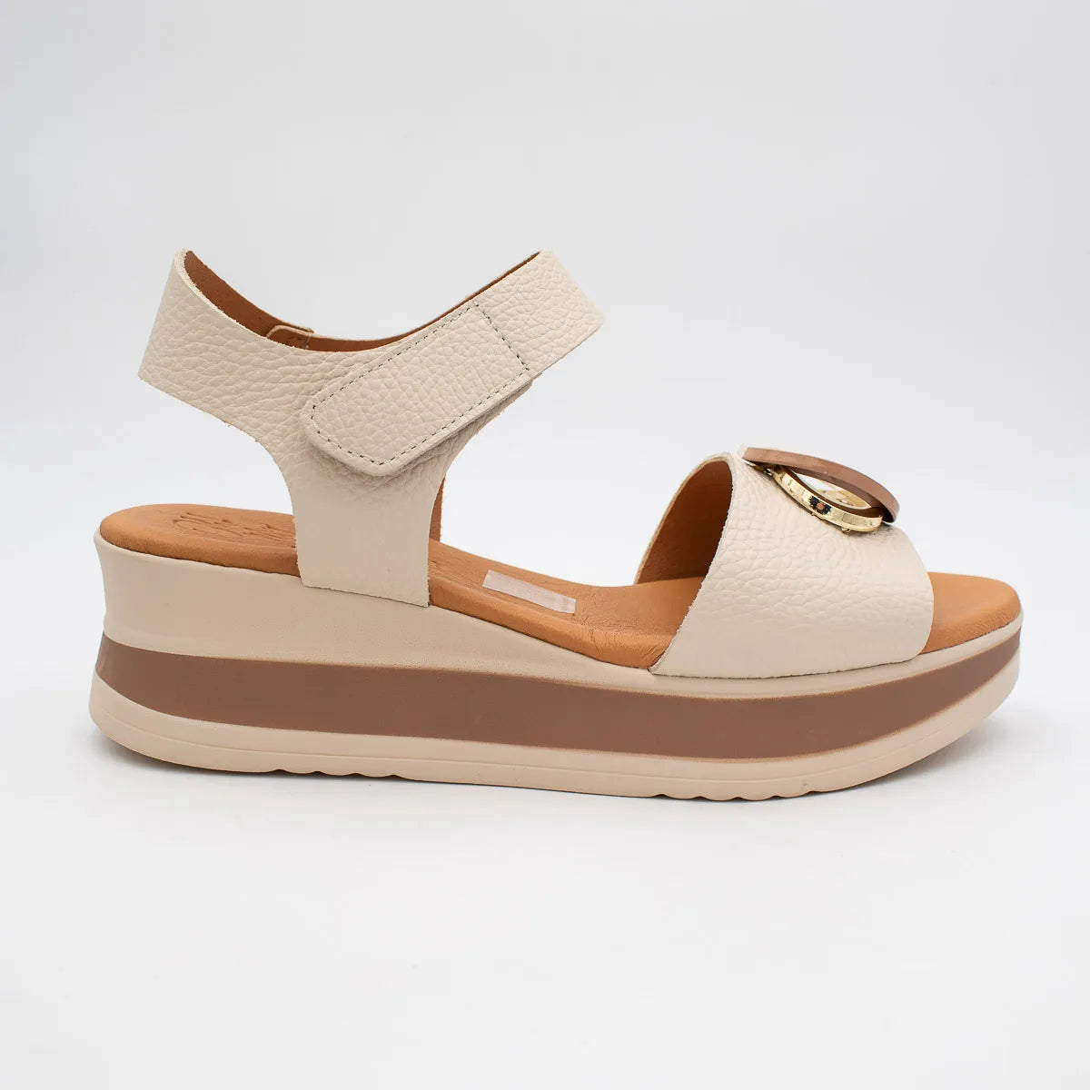 Beige sandal with brown sole on a white background