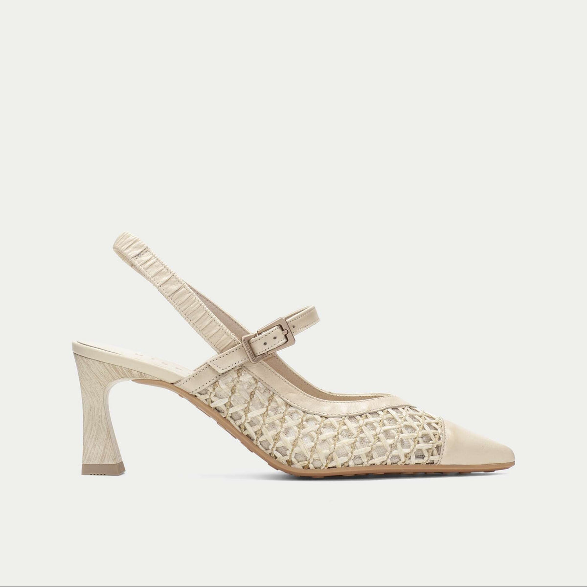 Beige high-heeled shoe with lace detailing on a light gray background