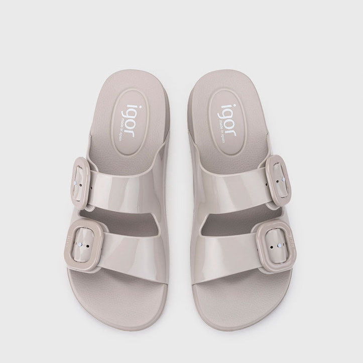 Pair of beige sandals with buckles on a white background