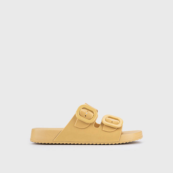 Yellow sandal with double straps on a light gray background