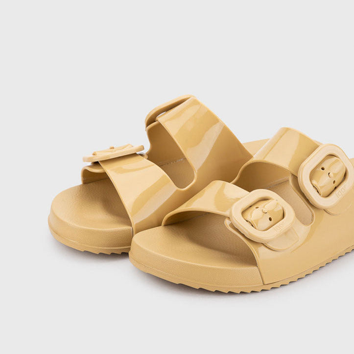 Beige sandals with buckle straps on a light gray background