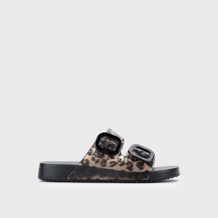 Black slide sandal with leopard print straps on a light gray background