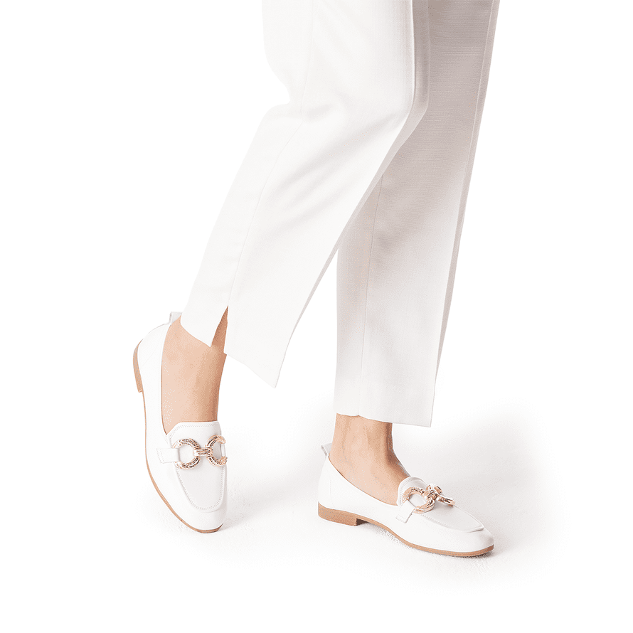 Stylish Woman wearing the loafers with white suit pants.