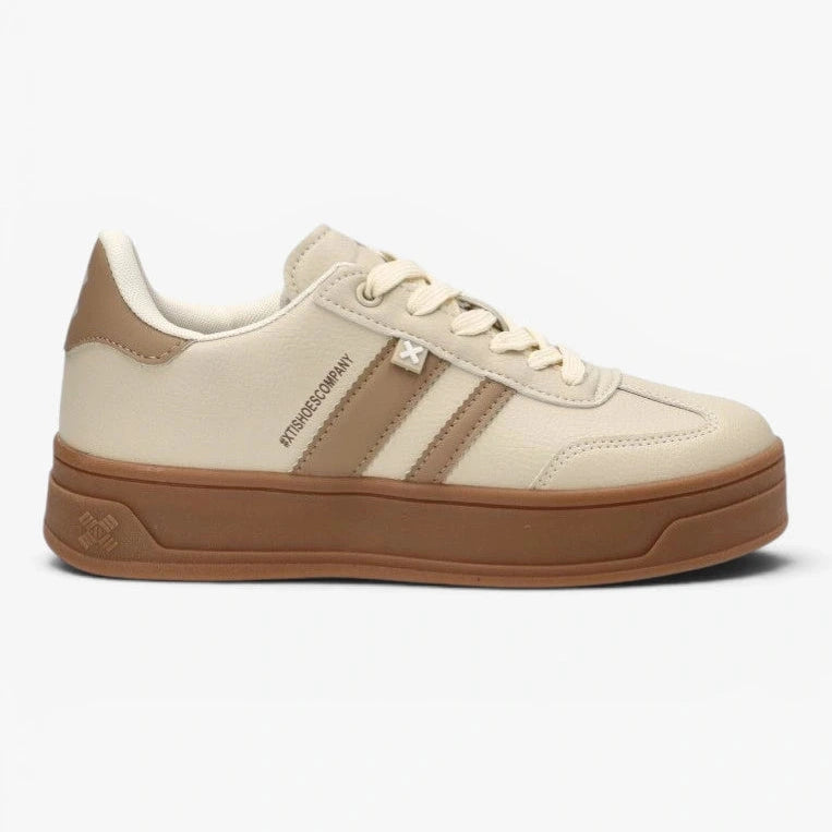 Beige sneaker with brown sole on a white background