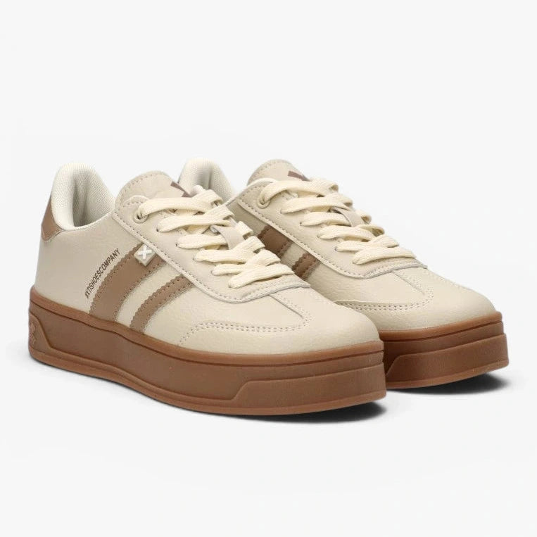 Beige sneakers with brown soles on a white background