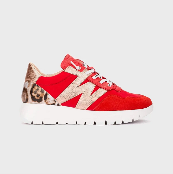 Red sneaker with leopard print accents on a light gray background