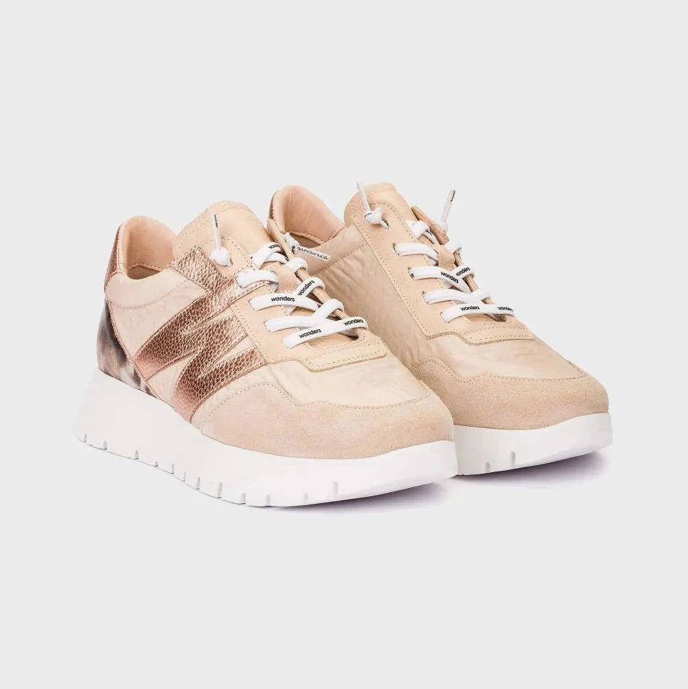 Beige sneakers with white soles on a light gray background