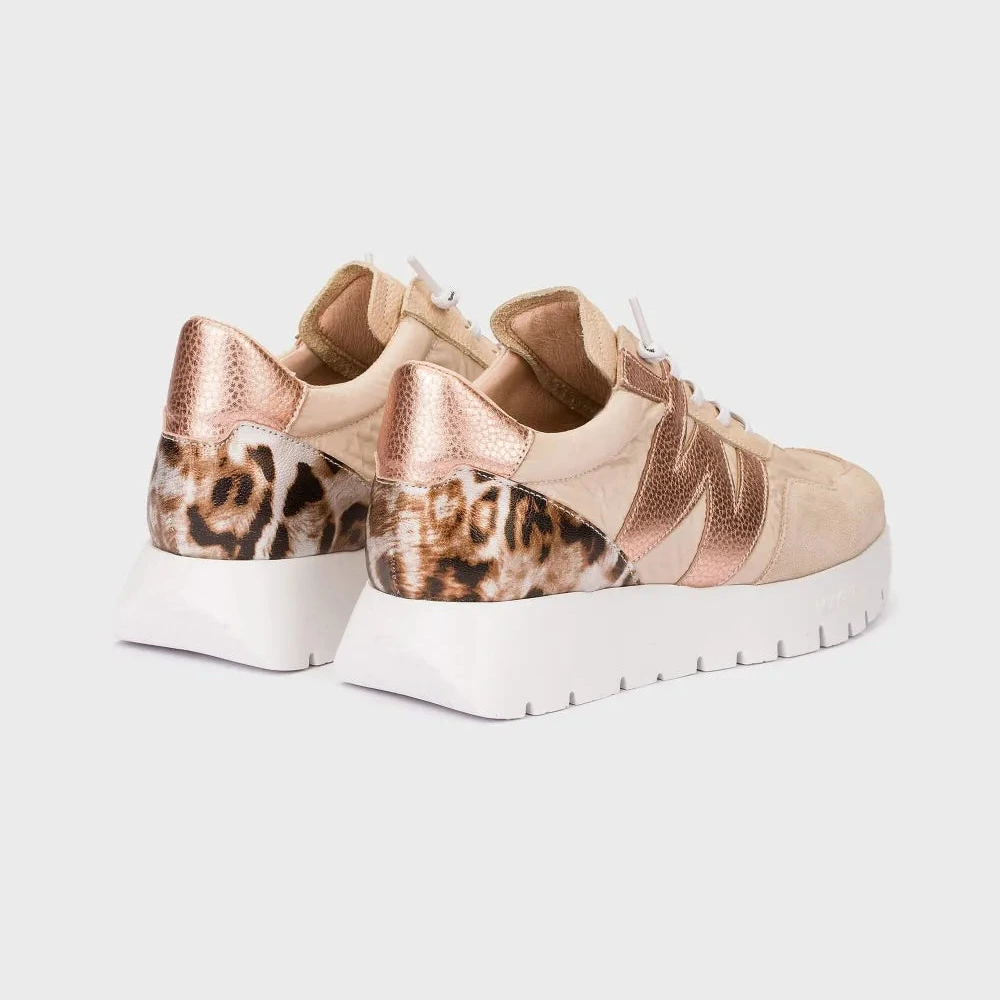 Beige sneakers with leopard print details on a light gray background