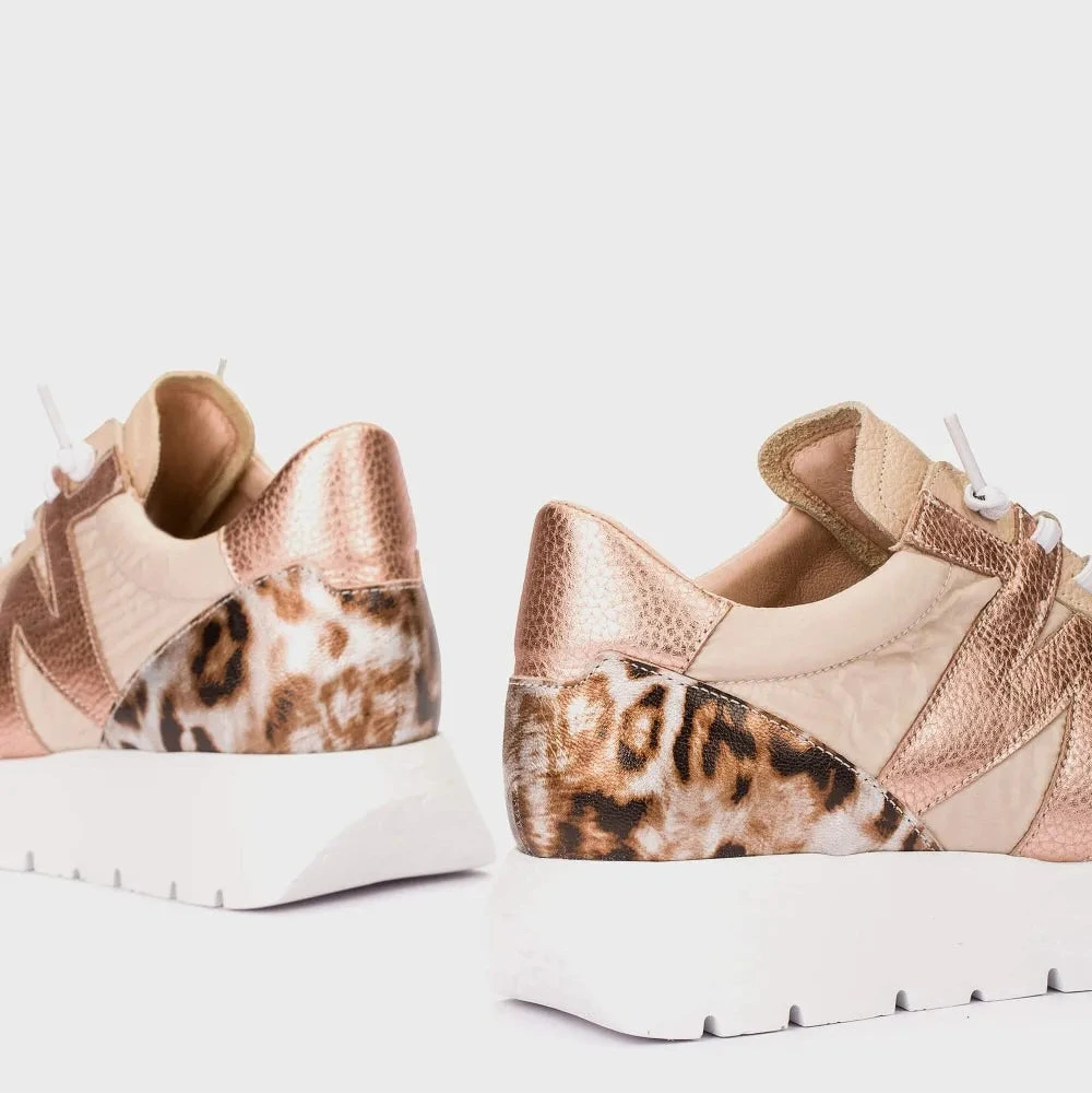 Pair of sneakers with leopard print pattern on a white background
