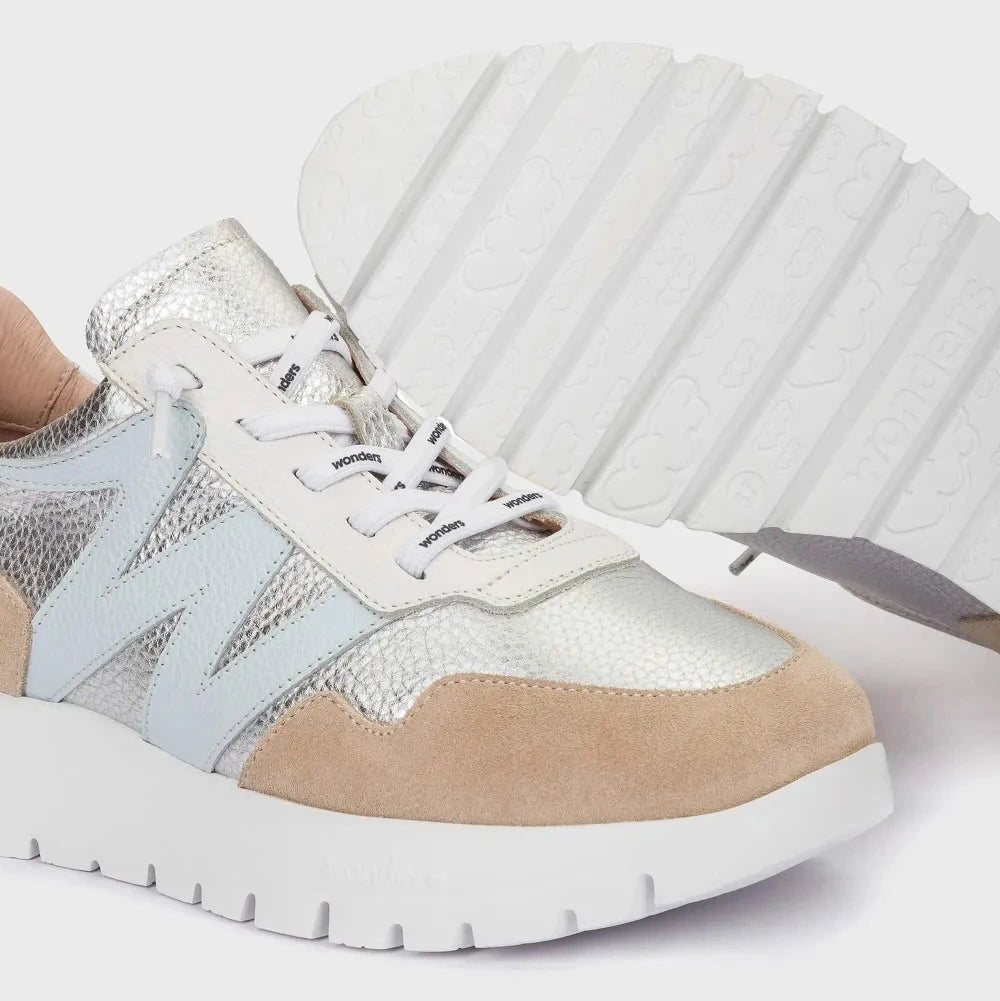 Multicolored sneaker with white sole on a light gray background