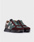Side angle of the Odisei Sneaker, emphasizing the unique green and burgundy blend.
