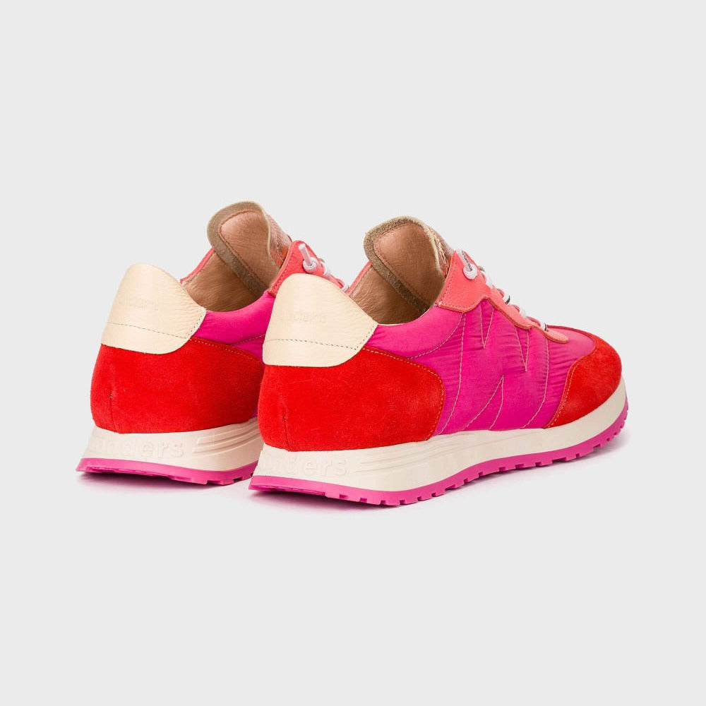 Red and pink sneakers with beige soles on a light gray background