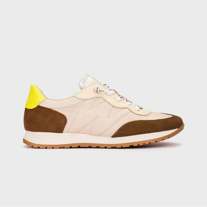 Sneaker with brown and yellow accents on a light gray background